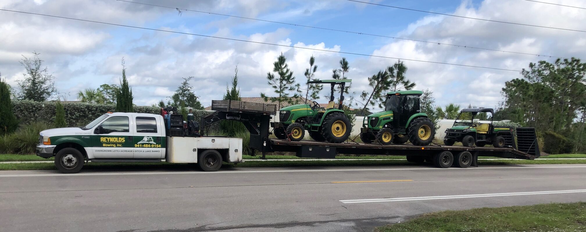 Reynolds Mowing Inc. Service Truck and Mowing Equipment on Trailer to job site